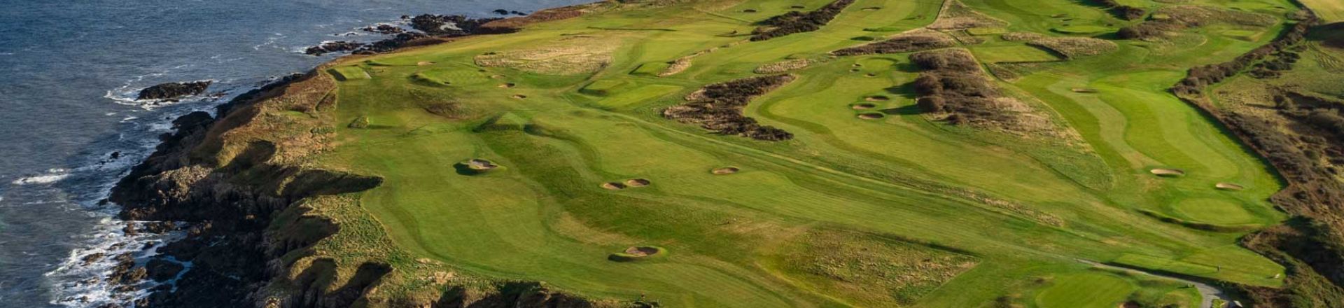 Experience the coastal splendour of Clwb Golff Nefyn Golf Club. This captivating image showcases the unique beauty of one of North Wales' premier golfing destinations, featuring meticulously designed fairways set against the backdrop of the Irish Sea.